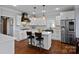 Modern kitchen with white cabinets, quartz countertops, and stainless steel appliances at 18912 Peninsula Point Dr, Cornelius, NC 28031