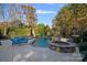 Inviting pool and spa area with lounge chairs and lush landscaping at 18912 Peninsula Point Dr, Cornelius, NC 28031