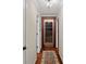 Temperature-controlled wine cellar with wood-framed door and flooring at 18912 Peninsula Point Dr, Cornelius, NC 28031