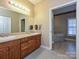 Double vanity bathroom with wood cabinets and a large soaking tub at 25040 Timberlake Dr, Tega Cay, SC 29708