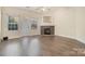 Living room with fireplace, hardwood floors, and access to a patio at 3116 Village Glen Ln, Charlotte, NC 28269