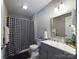 Updated bathroom features gray vanity, shower/tub combo, and a large mirror at 3215 24Th Ne St, Hickory, NC 28601