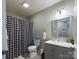 Clean bathroom with gray vanity, shower/tub combo, and black and white checkered shower curtain at 3215 24Th Ne St, Hickory, NC 28601