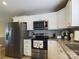 Modern kitchen with white cabinets, granite counters, and stainless steel appliances at 3215 24Th Ne St, Hickory, NC 28601