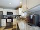 Modern kitchen with white cabinets, granite countertops, and stainless steel appliances at 3215 24Th Ne St, Hickory, NC 28601