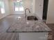 Modern kitchen island with granite countertop and stainless steel sink at 53 Travora Cir, York, SC 29745