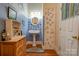 Small bathroom with pedestal sink, blue tile, and floral accents at 600 W Warren St, Shelby, NC 28150