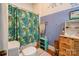 Bathroom with teal accents, patterned shower curtain, and tiled walls at 600 W Warren St, Shelby, NC 28150