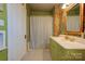 Bathroom with green vanity, shower, and patterned floor at 600 W Warren St, Shelby, NC 28150