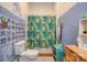 Bathroom with blue tile, patterned shower curtain, and wooden vanity at 600 W Warren St, Shelby, NC 28150