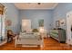 Charming bedroom with hardwood floors, white bed frame, and dresser at 600 W Warren St, Shelby, NC 28150