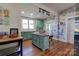 Kitchen boasts teal cabinets, stainless steel appliances, and a painted mural at 600 W Warren St, Shelby, NC 28150