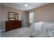 Bright bedroom with ceiling fan, plush carpet, and large window at 6360 Day Lilly Ln, Charlotte, NC 28216