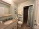 Main bathroom with walk-in shower, grab bars, and granite vanity at 7855 Nc Highway 90 E None, Stony Point, NC 28678