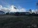 Ranch house back view, showcasing a large yard at 7855 Nc Highway 90 E None, Stony Point, NC 28678