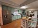 Charming kitchen with light green cabinets and wood floors at 7855 Nc Highway 90 E None, Stony Point, NC 28678