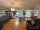 Open living room with hardwood floors, view into kitchen, and access to dining area at 7855 Nc Highway 90 E None, Stony Point, NC 28678