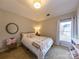 Bright bedroom with a queen-size bed, carpet flooring, and plenty of natural light at 8905 Parkcrest St, Huntersville, NC 28078