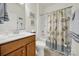 Bathroom with tub shower combination and wooden vanity at 1042 Gregory Jon Ct, Fort Mill, SC 29707