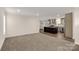 Open living room with carpet flooring and a view into the kitchen at 1100 Turkey Creek Ridge Rd, York, SC 29745