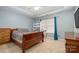 Main bedroom with wooden furniture, carpet, and soft blue walls at 1351 Hollythorn Dr, Rock Hill, SC 29732