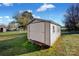 White storage shed in the backyard provides extra storage at 1411 Pearl St, Statesville, NC 28677