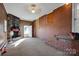 Sunroom with brick wall, stone fireplace and carpet flooring at 1411 Pearl St, Statesville, NC 28677