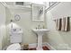 Classic powder room featuring pedestal sink and wainscoting at 1727 Will Schronce Rd, Lincolnton, NC 28092