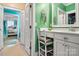 Bathroom with green walls, white vanity, and view of bedroom at 1727 Will Schronce Rd, Lincolnton, NC 28092