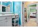 Clean bathroom with white vanity, teal walls, and view of another bedroom at 1727 Will Schronce Rd, Lincolnton, NC 28092