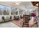 Spacious screened porch, wicker furniture, and string lights at 1727 Will Schronce Rd, Lincolnton, NC 28092