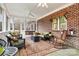 Enclosed porch with seating area and brick wall at 1727 Will Schronce Rd, Lincolnton, NC 28092