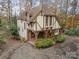 Aerial view showcasing a waterfront home nestled among autumn trees at 173 Driftwood Dr, Troutman, NC 28166