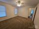 Bedroom with carpet, ceiling fan, and access to another room at 179 Delwood Ct, Mount Gilead, NC 27306