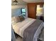 Cozy bedroom with a double bed and wooden storage at 204 Lake Tillery Trl, Mount Gilead, NC 27306