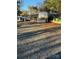 Empty RV lot with gravel and surrounding trees at 204 Lake Tillery Trl, Mount Gilead, NC 27306