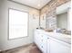 Clean bathroom with double vanity, white cabinets, and brick feature wall at 250 Buckshot Trl, Salisbury, NC 28146