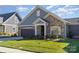 Gray and stone modern craftsman home with two car garage and well manicured lawn at 4014 Pleasant Run Dr, Matthews, NC 28104