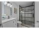 Modern bathroom with updated vanity, a frameless glass shower, and elegant lighting at 415 E Horah St, Salisbury, NC 28144