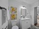 Updated bathroom with white vanity and gray floor tile at 415 E Horah St, Salisbury, NC 28144