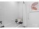 Clean bathroom with a bathtub, shower, and neutral tile at 4875 Polo Gate Blvd, Charlotte, NC 28216