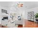 Spacious living room with hardwood floors, fireplace, and access to sunroom at 4875 Polo Gate Blvd, Charlotte, NC 28216