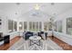 Sunroom with hardwood floors, plantation shutters, and comfy seating at 4875 Polo Gate Blvd, Charlotte, NC 28216