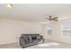 Spacious loft area with plush sofa and ceiling fan at 8537 Westhope St, Charlotte, NC 28216