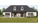 Home with covered patio, fire pit, and lush green lawn at 150A Lookout Dam Rd, Statesville, NC 28625