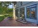 Brick patio with a bistro set, adjacent to the home's exterior at 2014 New Hope Rd, Charlotte, NC 28203