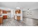 Open kitchen features wood cabinets, white appliances, and grey vinyl flooring at 203 Carwen Ct, Kannapolis, NC 28081