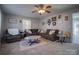 Spacious living room with gray sectional sofa and large windows at 3842 22Nd Street Ne Ct, Hickory, NC 28601