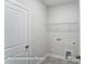 Bright laundry room with washer/dryer hookups and shelving at 4009 Grace Pointe Dr # 101, Indian Trail, NC 28079