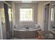 Spa-like bathroom featuring a large soaking tub and shower at 809 Pine Forest Rd, Charlotte, NC 28214